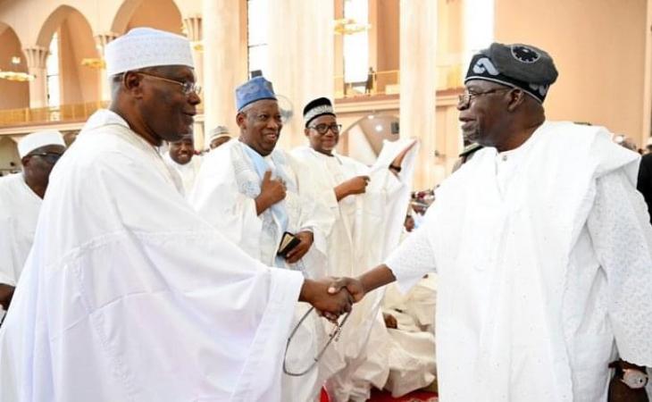 Atiku and Presdient Tinubu shaking hands at National Mosque, Abuja Friday